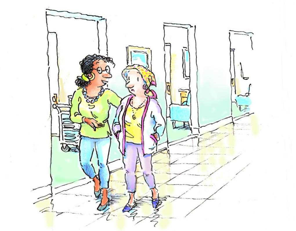 women walking in hospital corridor